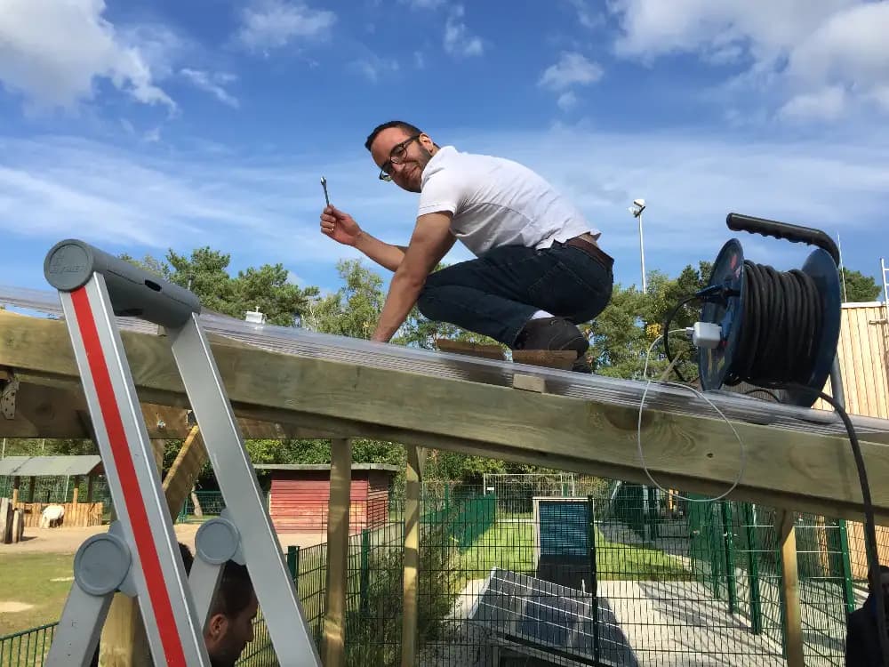 Solar energy student mounting solar panels.