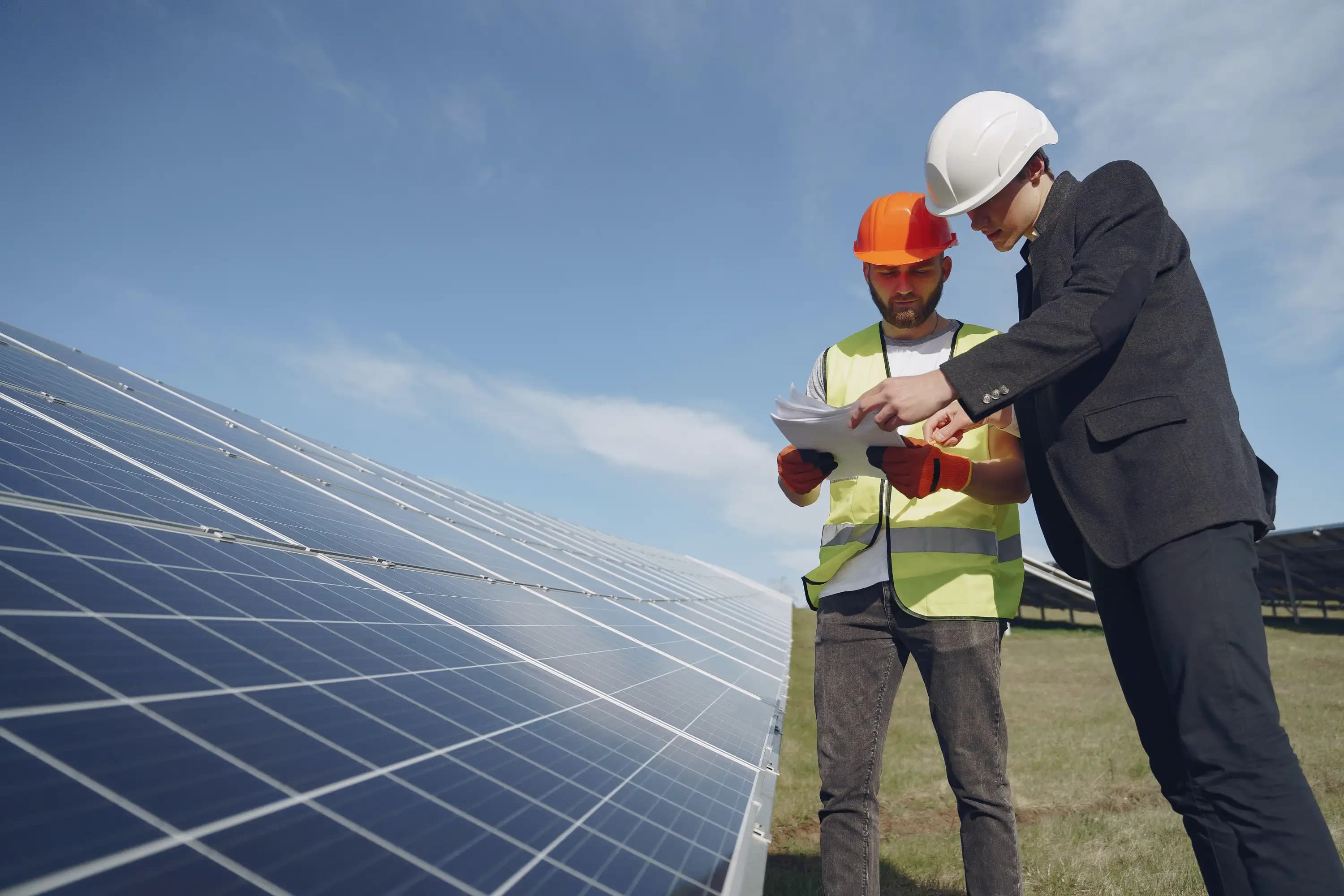 Solar energy employees working on a solar farm.